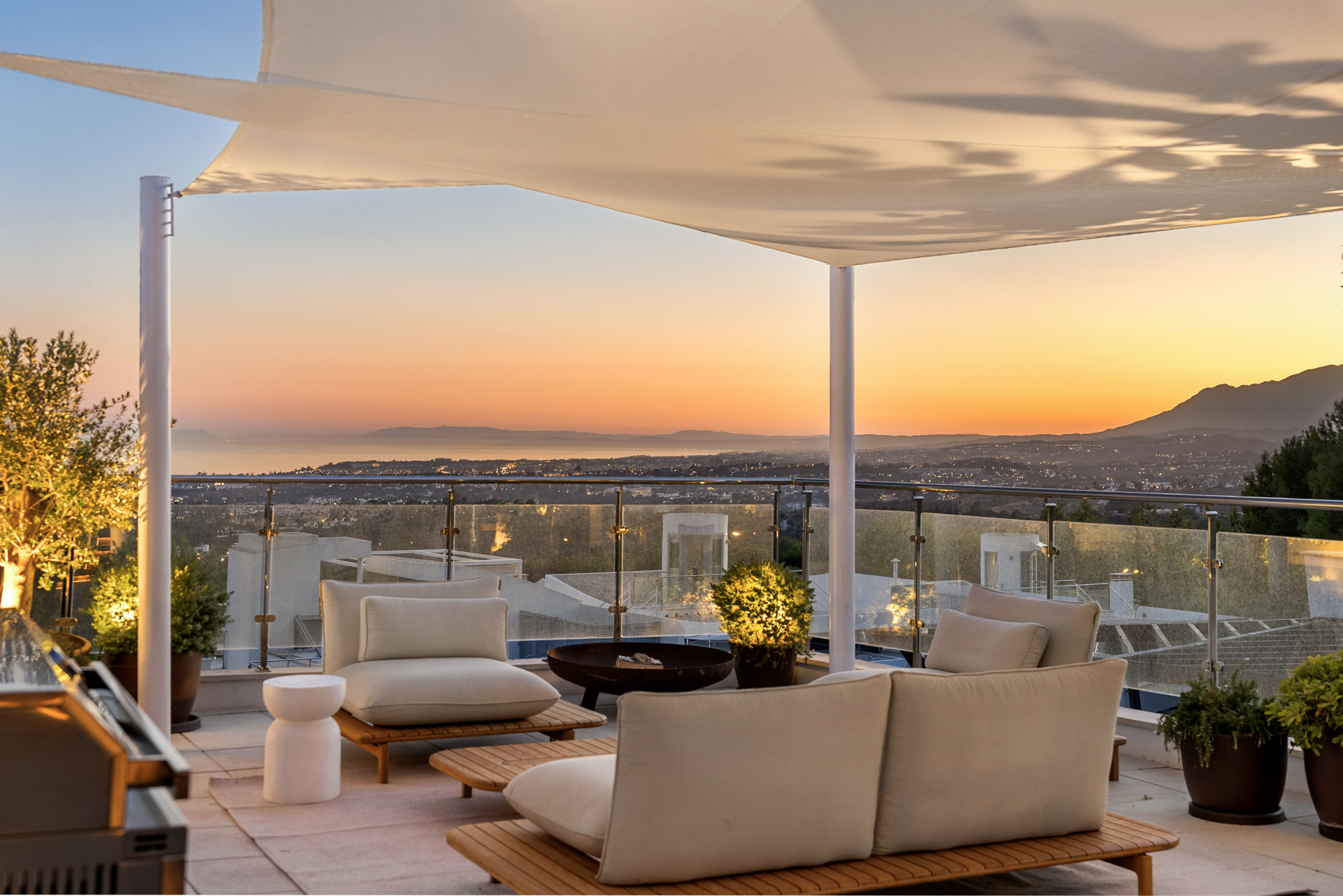 Marbella penthouse terrace at sunset with sea and mountain views